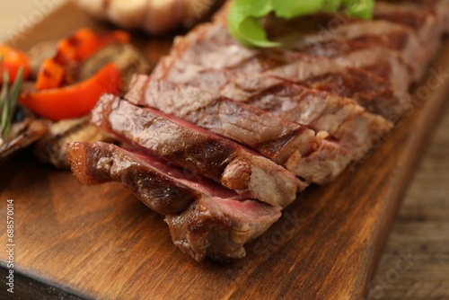 Delicious grilled beef steak on table, closeup