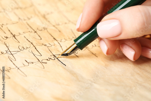 Woman writing letter with fountain pen  closeup