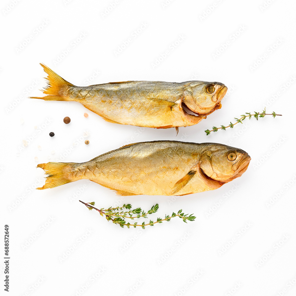 Cold smoked two sea fish carcass close up isolated on white background decorated with fresh sprig of thyme, crystals of coarse pink salt, black peppercorns. Salty snacks. Omega3 Cold smoked two sea fish carcass close up isolated on white background decorated with fresh sprig of thyme, crystals of coarse pink salt, black peppercorns. Salty snacks. Omega3