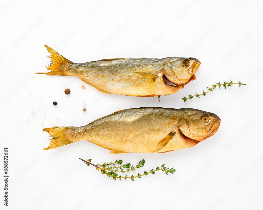 Cold smoked two sea fish carcass close up isolated on white background decorated with fresh sprig of thyme, crystals of coarse pink salt, black peppercorns. Salty snacks. Omega3 Cold smoked two sea fish carcass close up isolated on white background decorated with fresh sprig of thyme, crystals of coarse pink salt, black peppercorns. Salty snacks. Omega3