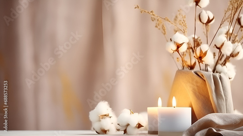 A stylish table with cotton flowers and aroma candles near the light wall. Banner for design A stylish table with cotton flowers and aroma candles near the light wall. Banner for design Flowers candle
