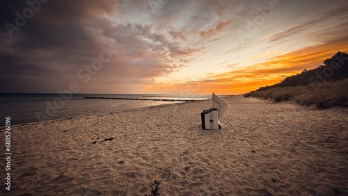 Fototapeta Naklejka Na Ścianę i Meble -  Sandy beach of Zingst on the Baltic Sea coast is bathed in the warm glow of sunset
