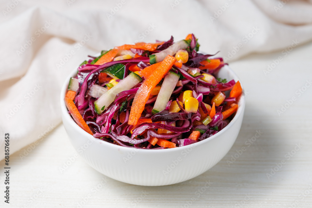 Healthy fresh salad with red cabbage, cucumber, carrot and corn in a bowl on white wooden table. Bright vegetarian food close up Healthy fresh salad with red cabbage, cucumber, carrot and corn in a bowl on white wooden table. Bright vegetarian food close up