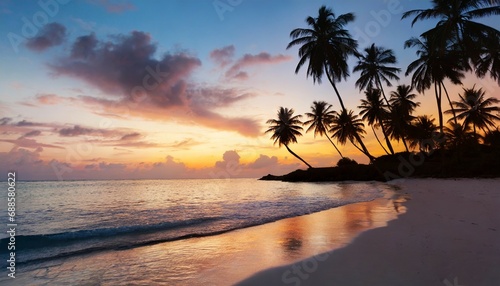 beautiful tropical beach with palm trees silhouettes at dusk