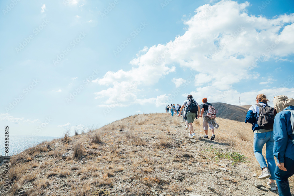 Tourists go hiking along the path to climb the mountain