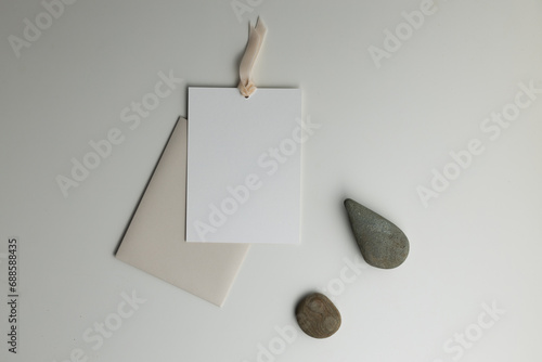 A composition with stones and a paper envelope with a postcard