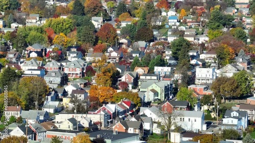 Residential suburb with colorful autumn trees. Aerial shot of neighborhood in American town. photo