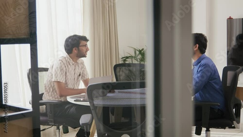A Modern Indian Asian Male Corporate Personnel Manager taking interview of a young job applicant or seeker followed by a firm Handshake as an compliment in a startup office Workplace.
