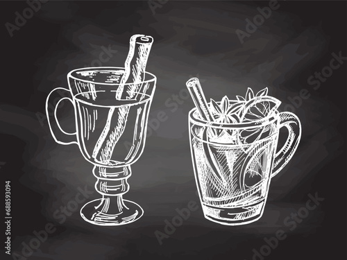 Hand-drawn sketch set of mugs with mulled wine on chalkboard background. Vector food drawing. A warming drink. Traditional Christmas drink. Vintage cozy seasonal holidays. Good for menu.