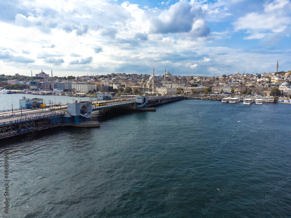 Beautiful drone view of Galata Bridge and Golden Horn Bay with passenger ferries, Istanbul, Turkey
