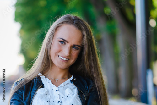 Young smiling woman outdoors portrait. Soft sunny colors.Closeup portrait.Summer day.