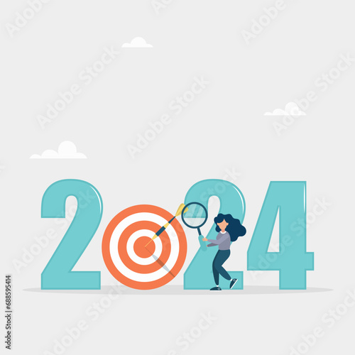 Analysis and development of business strategies for the new year 2024, planning and setting business goals. The girl looks through a magnifying glass in search of a goal for the new year.
