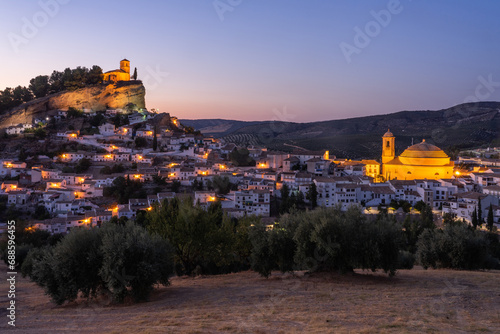 Panoramic view of Montefrio since National Geographic lookout with olive trees in the foreground illuminated at night. Granada, Andalucia, Spain. photo