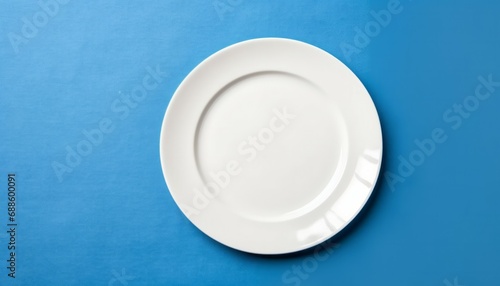 Top view empty round white plate on tablecloth for food on colored background. Empty dish on napkin with space for your design.
