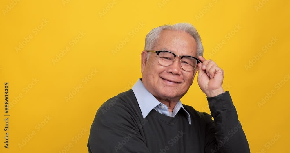 Close up, portrait of older man smiling and looking at the camera, isolated on yellow background in the studio. Close up, portrait of older man smiling and looking at the camera, isolated on yellow background in the studio.