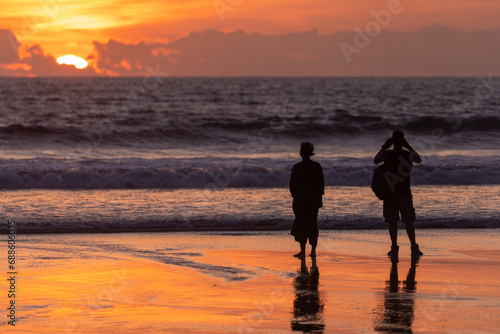 People on the beach in Seminyak at sunset, Bali Island, Indonesia
