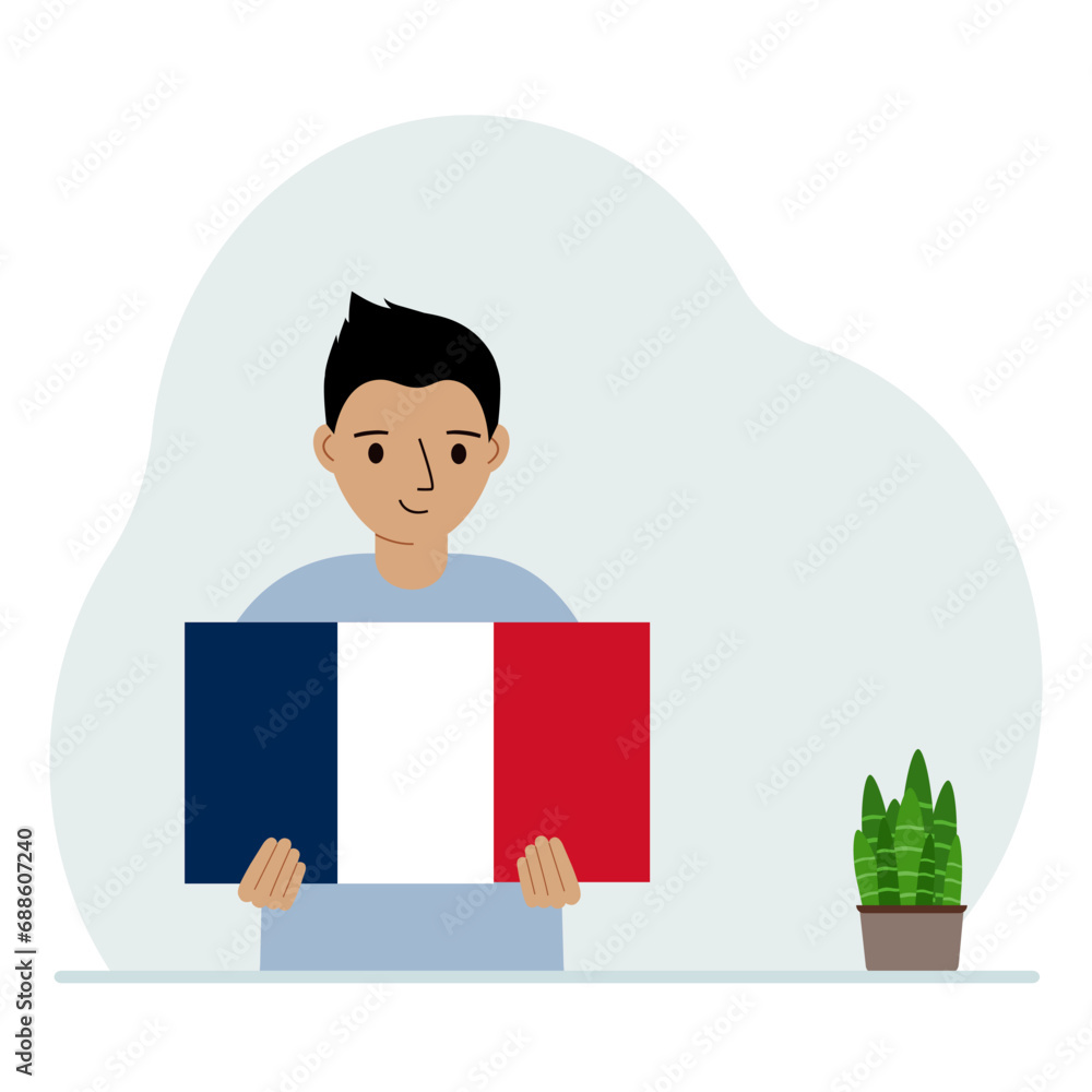 A little boy is holding the flag of France in his hands. The concept of demonstration, national holiday or patriotism. Nationality. A little boy is holding the flag of France in his hands. The concept of demonstration, national holiday or patriotism. Nationality.