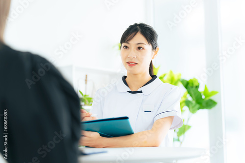 患者に問診する医療従事者の女性