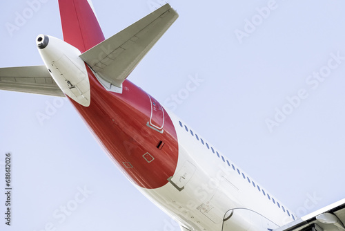 Canvas Print Tail rudder and fuselage of a passenger plane on a thin sky day