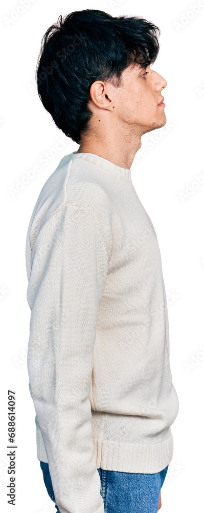 Handsome hipster young man wearing casual winter sweater looking to side, relax profile pose with natural face with confident smile. Handsome hipster young man wearing casual winter sweater looking to side, relax profile pose with natural face with confident smile.