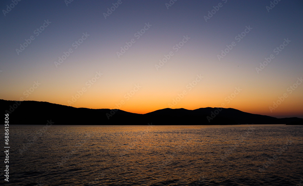 Tourism and sea travel. Holidays at sea. Sunset over the sea.