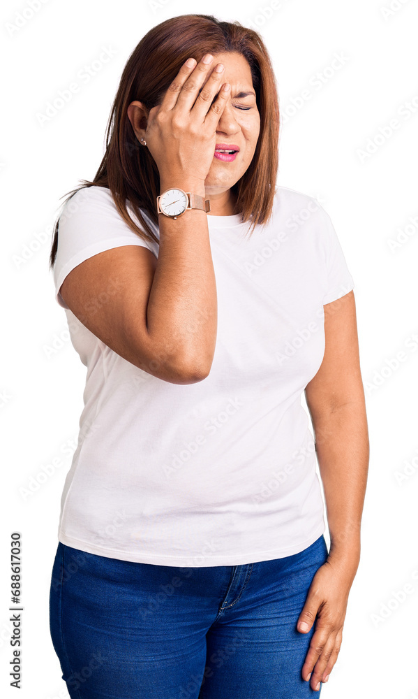 Middle age latin woman wearing casual white tshirt yawning tired covering half face, eye and mouth with hand. face hurts in pain. Middle age latin woman wearing casual white tshirt yawning tired covering half face, eye and mouth with hand. face hurts in pain.