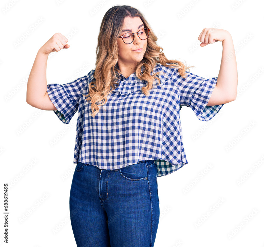 Young caucasian woman wearing casual clothes showing arms muscles smiling proud. fitness concept. Young caucasian woman wearing casual clothes showing arms muscles smiling proud. fitness concept.