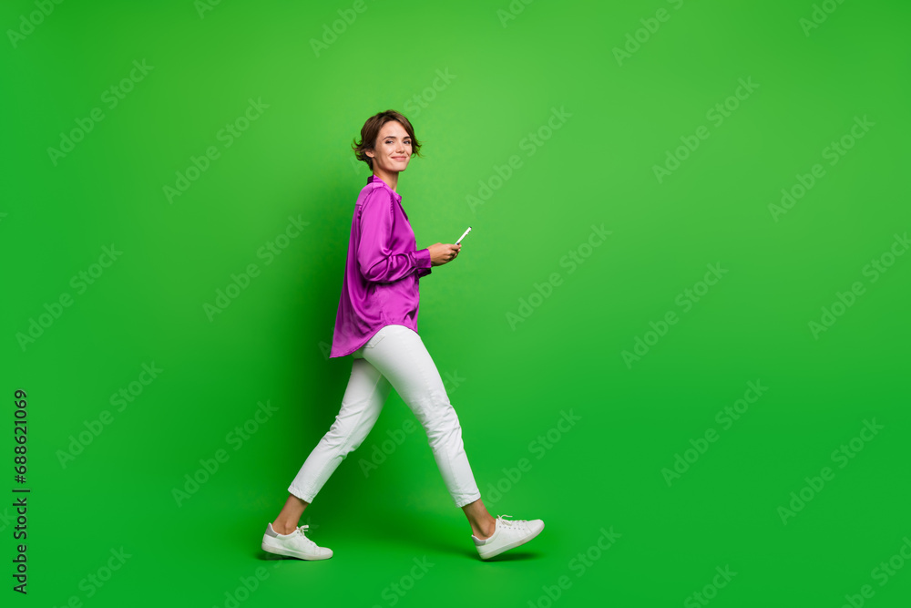 Profile side photo of charming gorgeous girl dressed trendy purple clothes going office empty space isolated on green color background Profile side photo of charming gorgeous girl dressed trendy purple clothes going office empty space isolated on green color background