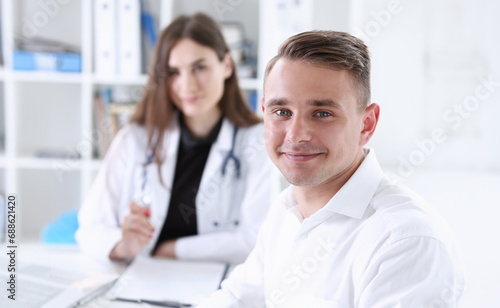 Wallpaper Mural Satisfied happy handsome smiling male patient with doctor at her office. High level and quality medical service therapeutist consultation work and career physical healthy lifestyle concept Torontodigital.ca