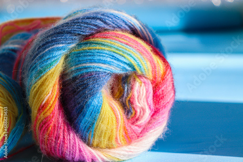 Selective focus. Multi-colored threads for knitting. Rainbow texture.