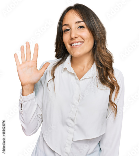 Young brunette woman wearing casual clothes showing and pointing up with fingers number five while smiling confident and happy.