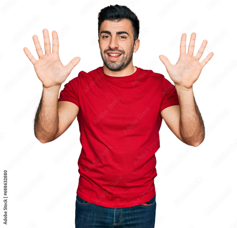 Hispanic man with beard wearing casual red t shirt showing and pointing up with fingers number ten while smiling confident and happy. Hispanic man with beard wearing casual red t shirt showing and pointing up with fingers number ten while smiling confident and happy.