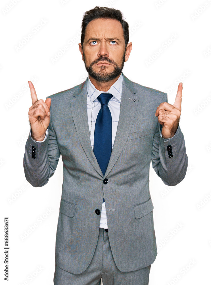 Middle age man wearing business clothes pointing up looking sad and upset, indicating direction with fingers, unhappy and depressed. Middle age man wearing business clothes pointing up looking sad and upset, indicating direction with fingers, unhappy and depressed.