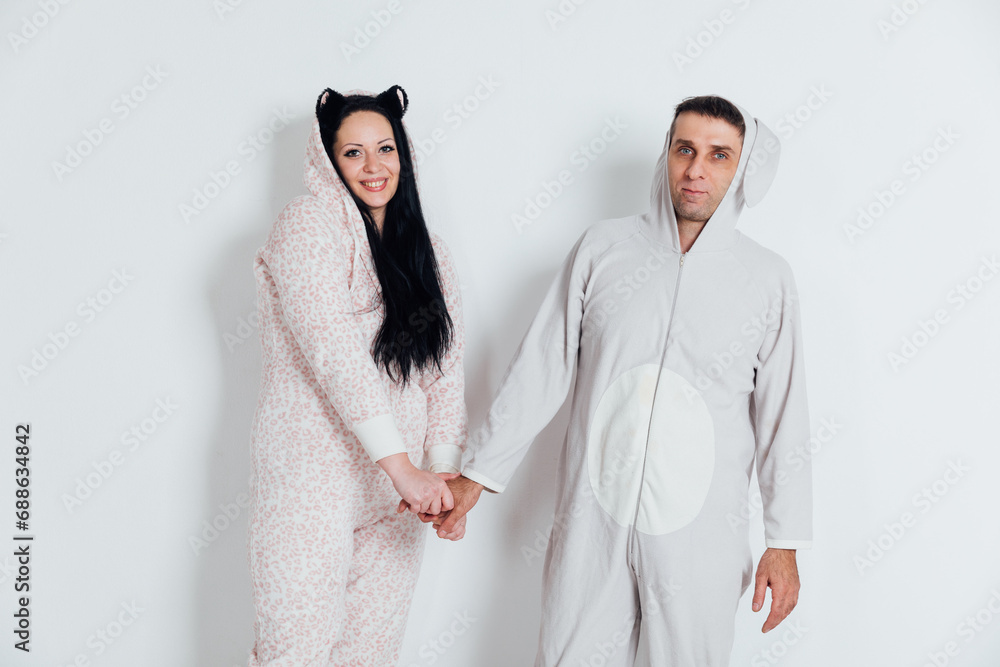 Husband and wife Man and woman in pajamas in the morning in a bright room Lovers