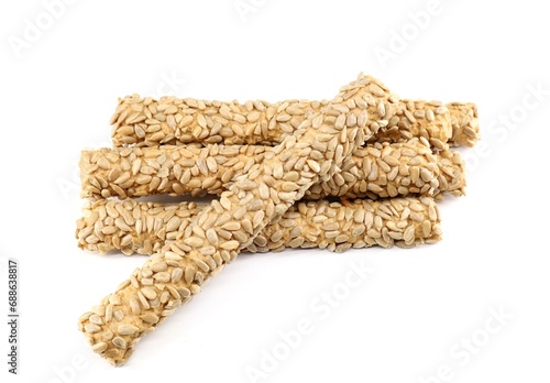 Group of bread sticks with sunflower seeds on white background.