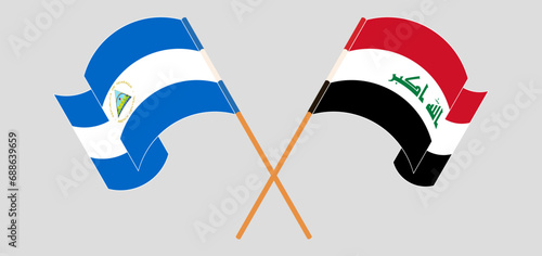 Crossed and waving flags of Nicaragua and Iraq