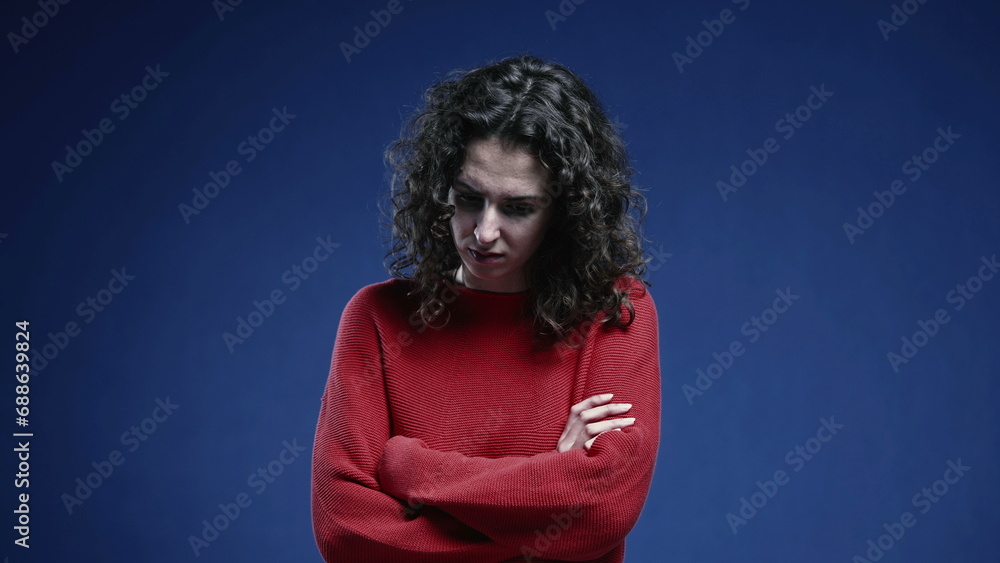 Fearful woman crossing arms feeling afraid and scared. Negative protective boduy language, feeling depressed and apprehensive Fearful woman crossing arms feeling afraid and scared. Negative protective boduy language, feeling depressed and apprehensive
