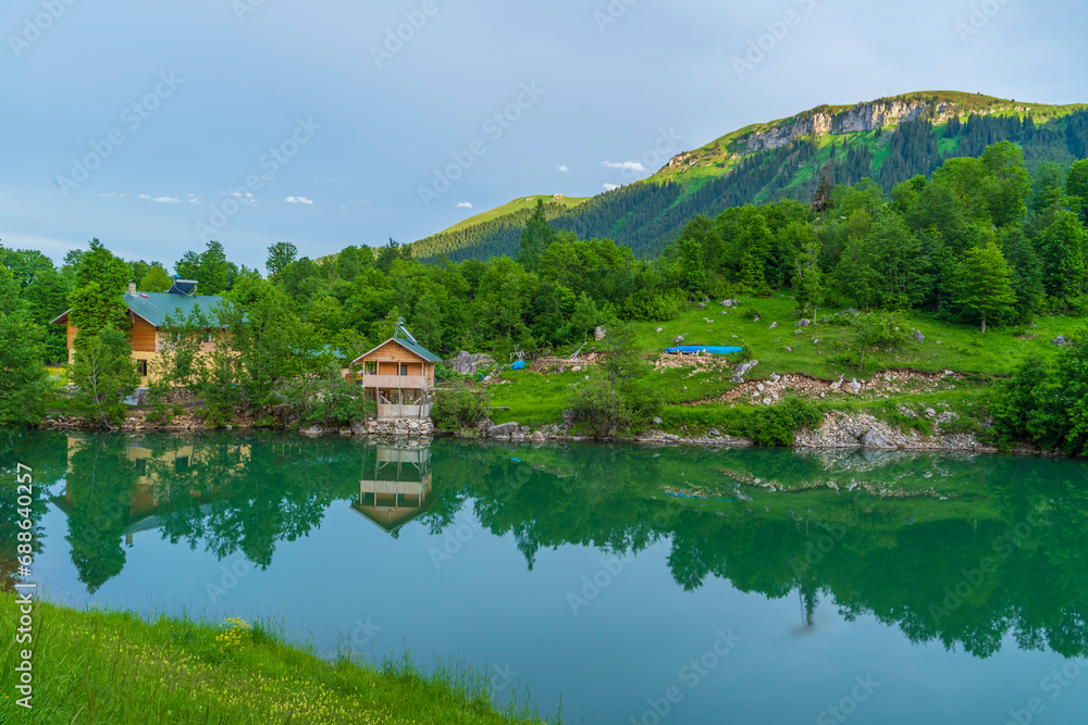 Houses in green highlands wonderful views surrounded by clouds and mountains the idea of living in nature Houses in green highlands wonderful views surrounded by clouds and mountains the idea of living in nature