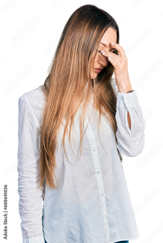 Beautiful caucasian woman wearing casual white shirt tired rubbing nose and eyes feeling fatigue and headache. stress and frustration concept. Beautiful caucasian woman wearing casual white shirt tired rubbing nose and eyes feeling fatigue and headache. stress and frustration concept.
