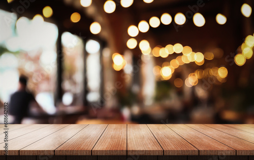 Empty wooden table top with lights bokeh on blur restaurant background