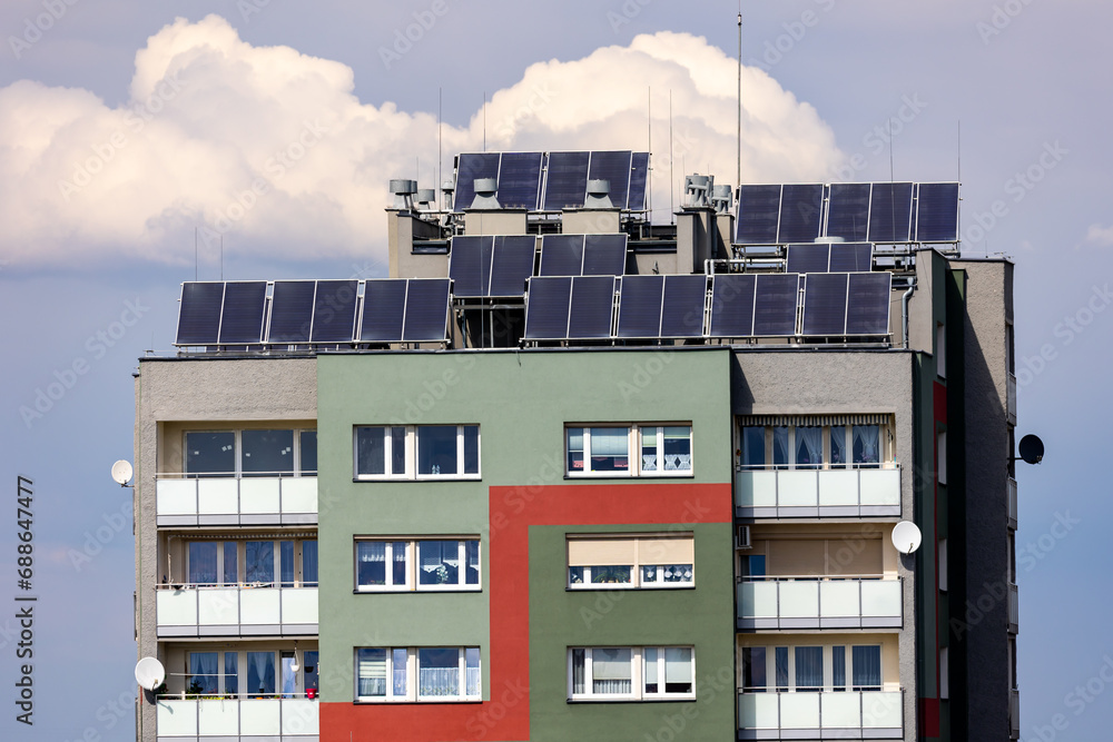 Photovoltaic, solar panels on the roof of a residential block. Production of electricity by prosumers using solar energy. Photo taken during the day, natural lighting conditions