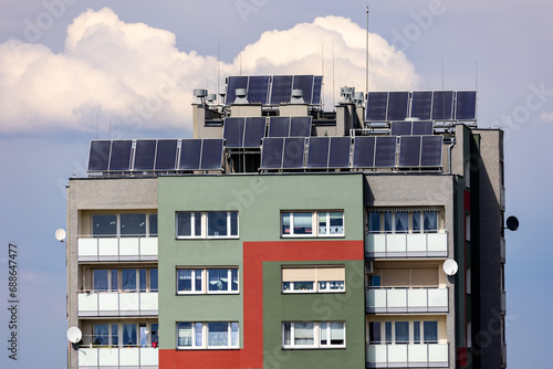 Obraz na płótnie Photovoltaic, solar panels on the roof of a residential block. Production of electricity by prosumers using solar energy. Photo taken during the day, natural lighting conditions w salonie