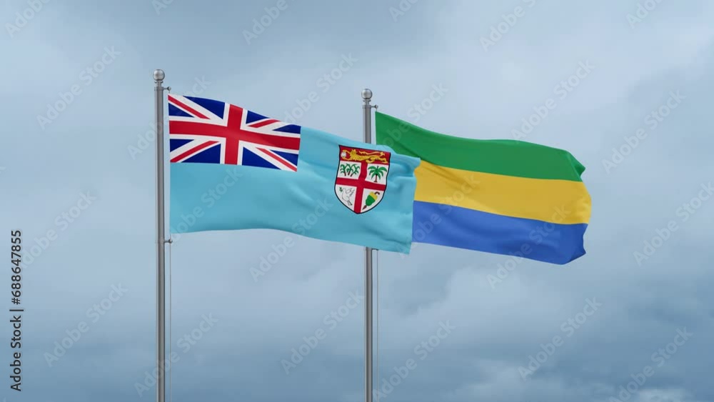 Gabon flag and Fiji flag waving together on cloudy sky, endless seamless loop, two country relations concept Gabon flag and Fiji flag waving together on cloudy sky, endless seamless loop, two country relations concept
