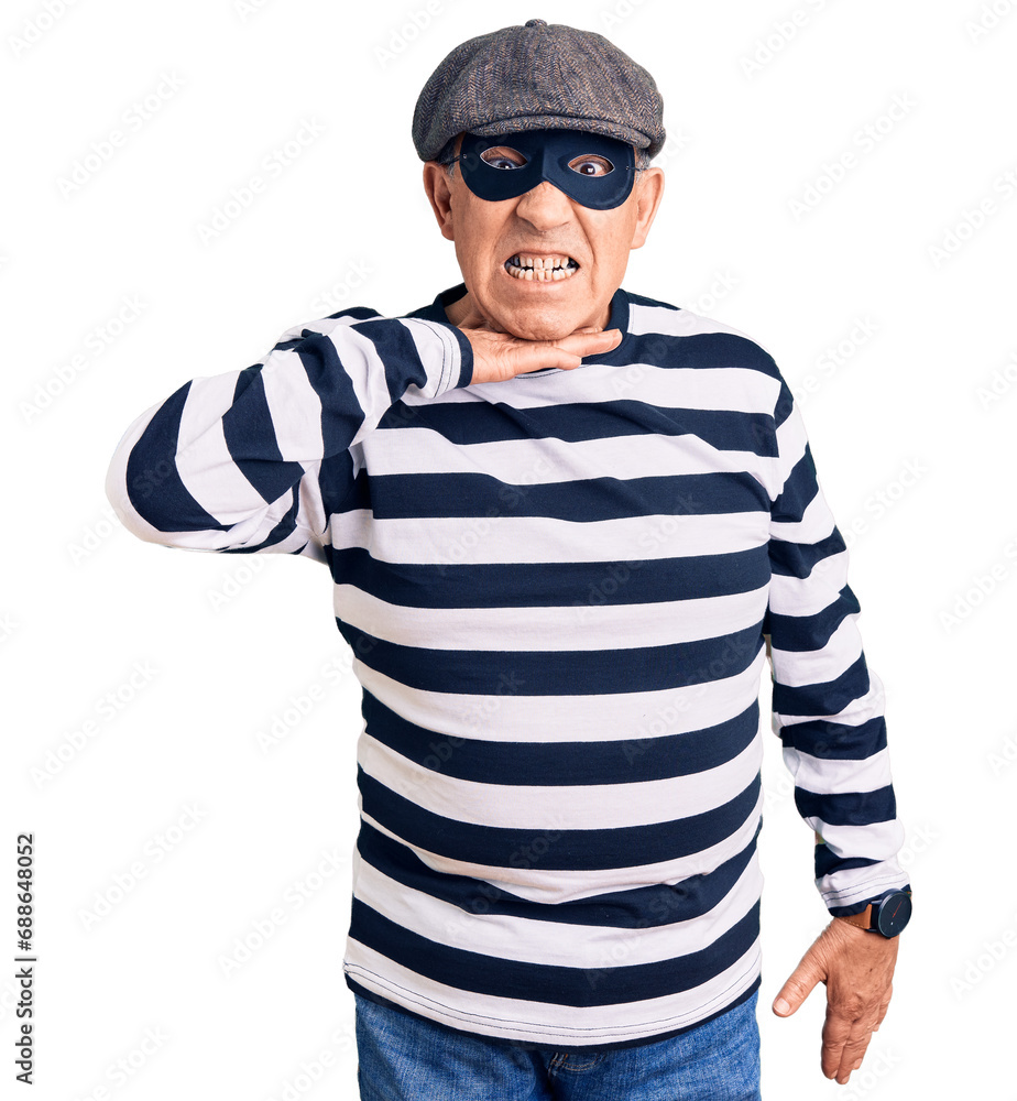 Senior handsome man wearing burglar mask and t-shirt cutting throat with hand as knife, threaten aggression with furious violence Senior handsome man wearing burglar mask and t-shirt cutting throat with hand as knife, threaten aggression with furious violence