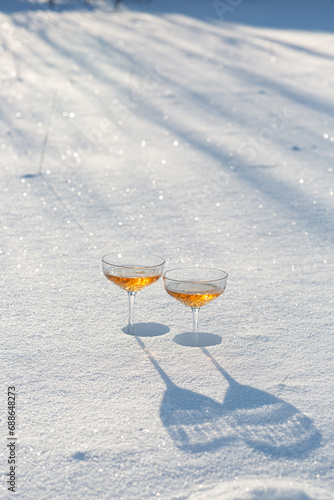 Two glasses of champagne in the snow