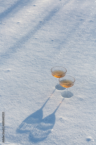 Two glasses of champagne in the snow