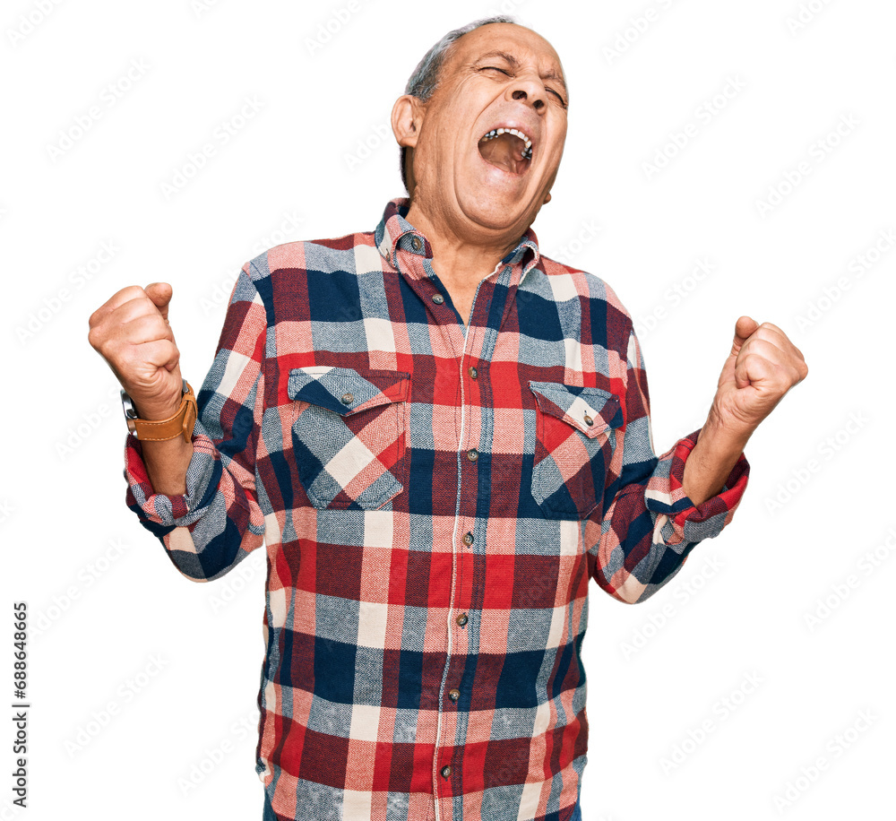 Senior hispanic man wearing casual clothes very happy and excited doing winner gesture with arms raised, smiling and screaming for success. celebration concept. Senior hispanic man wearing casual clothes very happy and excited doing winner gesture with arms raised, smiling and screaming for success. celebration concept.