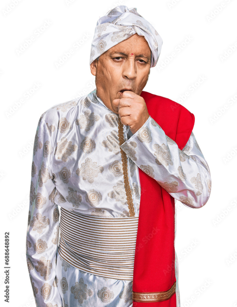 Senior hispanic man wearing tradition sherwani saree clothes feeling unwell and coughing as symptom for cold or bronchitis. health care concept. Senior hispanic man wearing tradition sherwani saree clothes feeling unwell and coughing as symptom for cold or bronchitis. health care concept.
