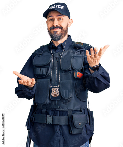 Young handsome man wearing police uniform smiling cheerful with open arms as friendly welcome, positive and confident greetings