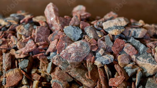 Red lumps of salt mined in the mines. Production of additives for fertile soil. photo